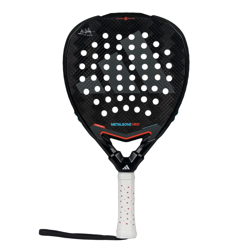The Adidas Metalbone HRD+ 3.4 Ale Galan 2025 padel racket features a perforated black surface with red accents. Tailored for offensive play, its handle includes a white grip with red dots, allowing match customization.