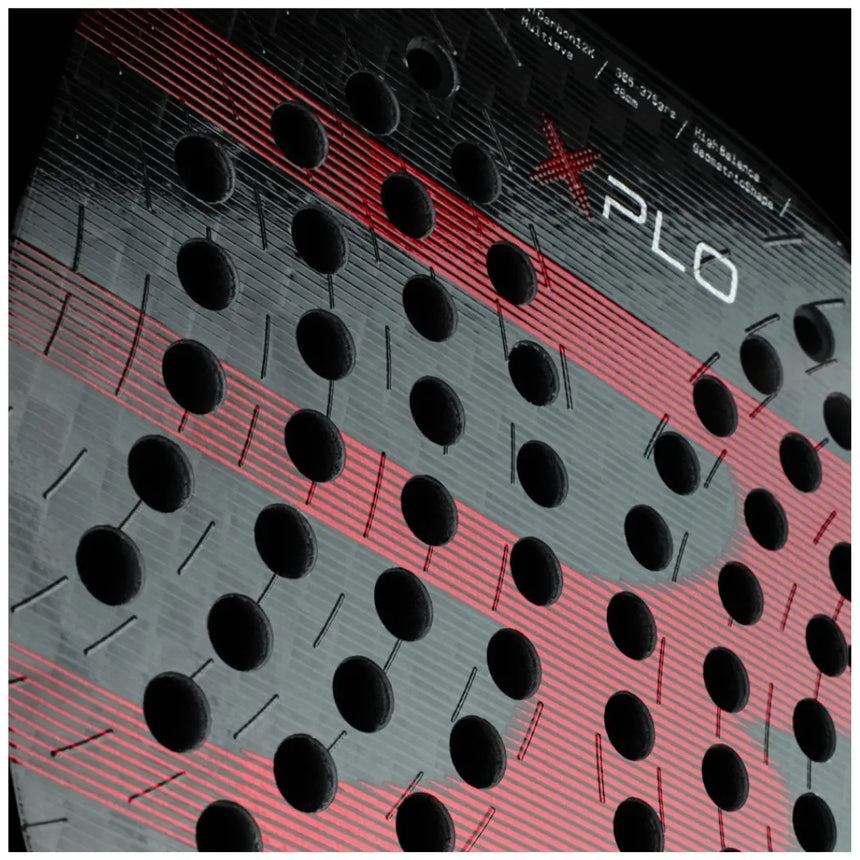 A close-up of the BULLPADEL RACKET XPLO 2025 MARTÍN DI NENNO by Padel Smash Academy highlights black hole patterns with red and black geometric stripes. The word XPLO is partially visible at the top.