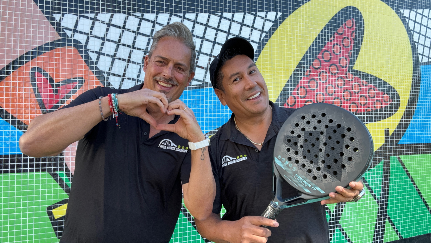 Cesc Caceres and Julian Wortelboer posing in front of some art at Wynwood art district holding Adidas Cross it Light Padel Racket