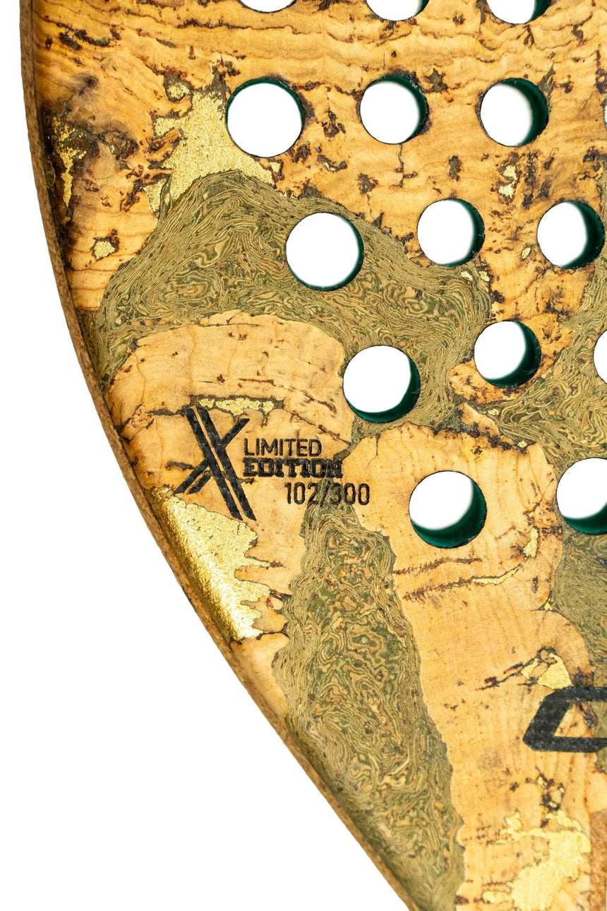 Close-up of the Cork Padel Extreme Green rackets wooden surface with green holes, marked Limited Edition 107/300. This exclusive Cork Padel piece features a light, natural grain pattern, ideal for professional players seeking style and performance.