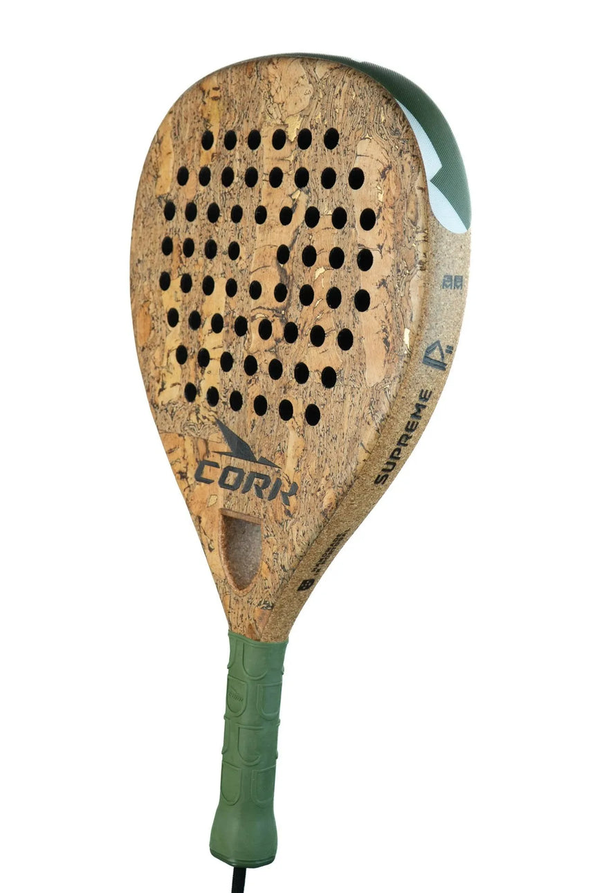 The Cork Padel Supreme Power III racket is designed for offensive players, crafted with a High Carbon Composition. It features a cork surface accented in green, a patterned grip, and perforations on the face. The branding text elegantly adorns the edges against a pristine white background.