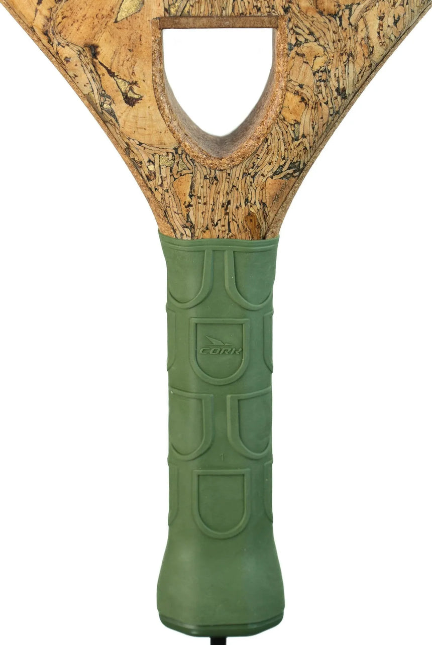 Close-up of a Cork Padel Supreme Power III pickleball paddle featuring a green rubber handle. The high carbon composition surface showcases a textured cork-like pattern, perfect for offensive players seeking precision and control.