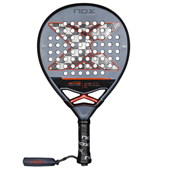 The Nox Padel Racket AT10 Genius 18K Alum 2025 by Agustin Tapia is a black and gray padel masterpiece with red accents and numerous holes for enhanced play. It features a black grip handle with NOX branding, Exclusive Spin Technology, and 18K Carbon Alum for superior performance.