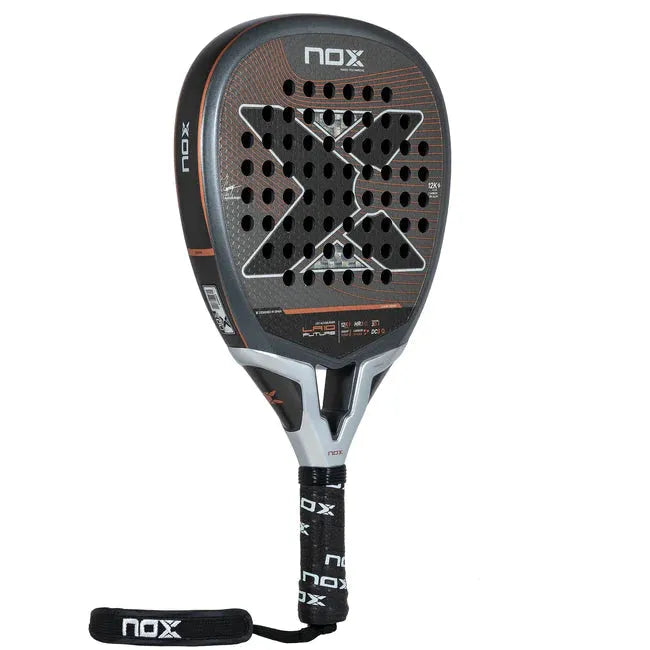 The NOX Padel Racket LA10 Future 2024 Leo Augsburger features a sleek design with a large X and perforations on its black and orange face. Made from aluminized 12K carbon fiber for enhanced power, it includes a black grip with NOX branding and a strap at the handles end for security.