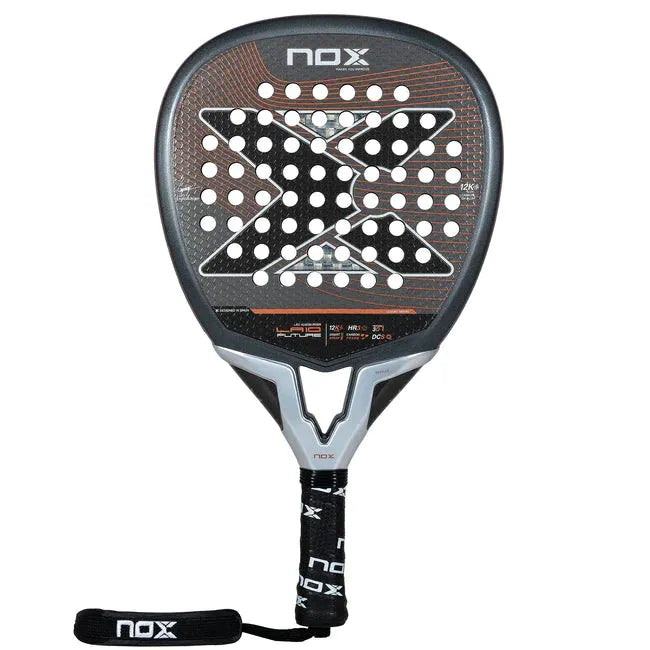 Close-up of the NOX Padel Racket LA10 Future 2024 Leo Augsburger, featuring an aluminized 12K carbon fiber design in black, gray, and orange. It boasts a perforated surface for enhanced power and includes a branded handle with a wrist strap.