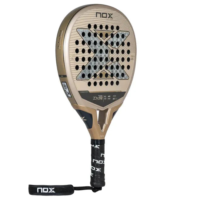 The NOX Padel Racket TL10 Future 2024 Tino Libaak features a gold and black teardrop shape with a black handle, strap, and X design. Made from aluminized 12K Carbon Fiber, it has a perforated face for versatile gameplay and a black grip with NOX printed on it.