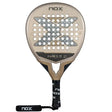 The NOX Padel Racket TL10 Future 2024 Tino Libaak boasts a gold and black teardrop shape with a perforated face, showcasing the brands signature X design. Its black handle features white branding and an attached wrist strap for versatile gameplay.