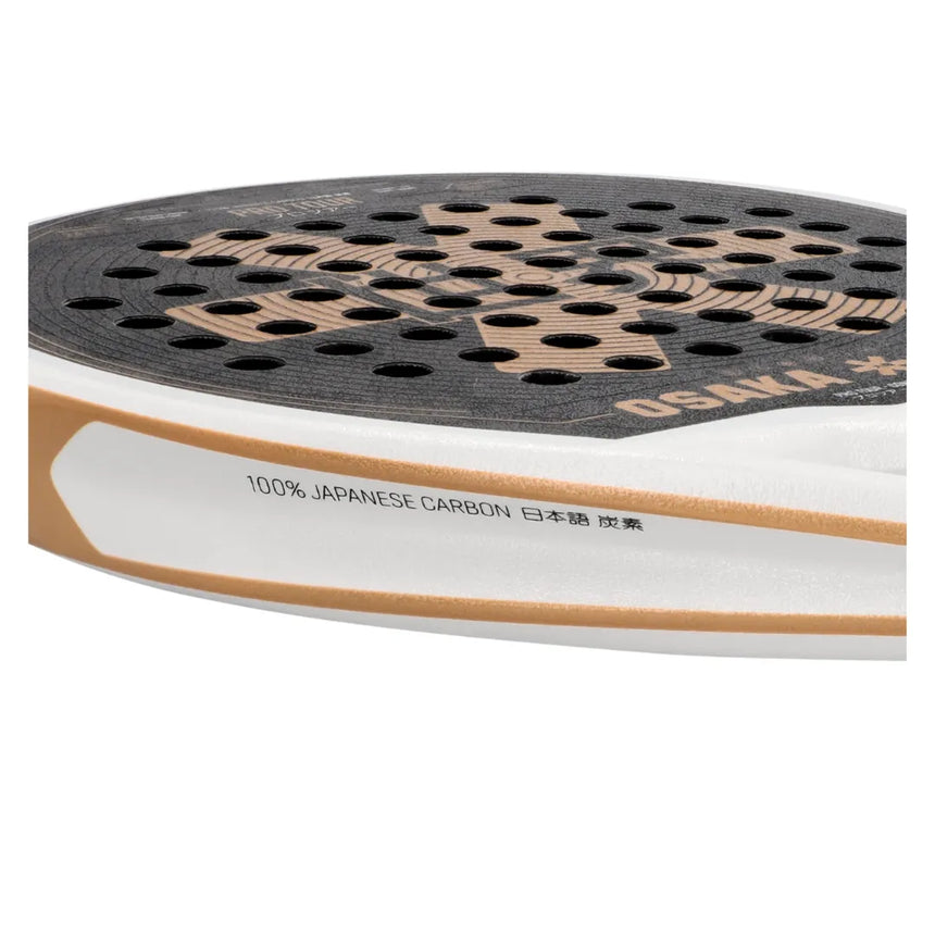 Close-up of a shoe sole with black perforated traction pad and beige accents. Featuring 100% JAPANESE CARBON and Japanese characters, the design invokes Osakas 2024 Padel Racket Pro Tour Control—modern, sporty elegance at its finest.