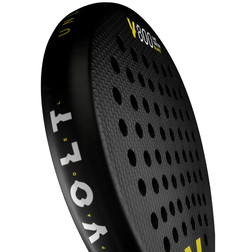 Close-up of the 3K carbon Volt 800 V23 padel racket features a black design with circular hole patterns for high control, highlighted by VOLT and V800 in white and yellow text and complemented by a Fast Recovery Black Eva core.