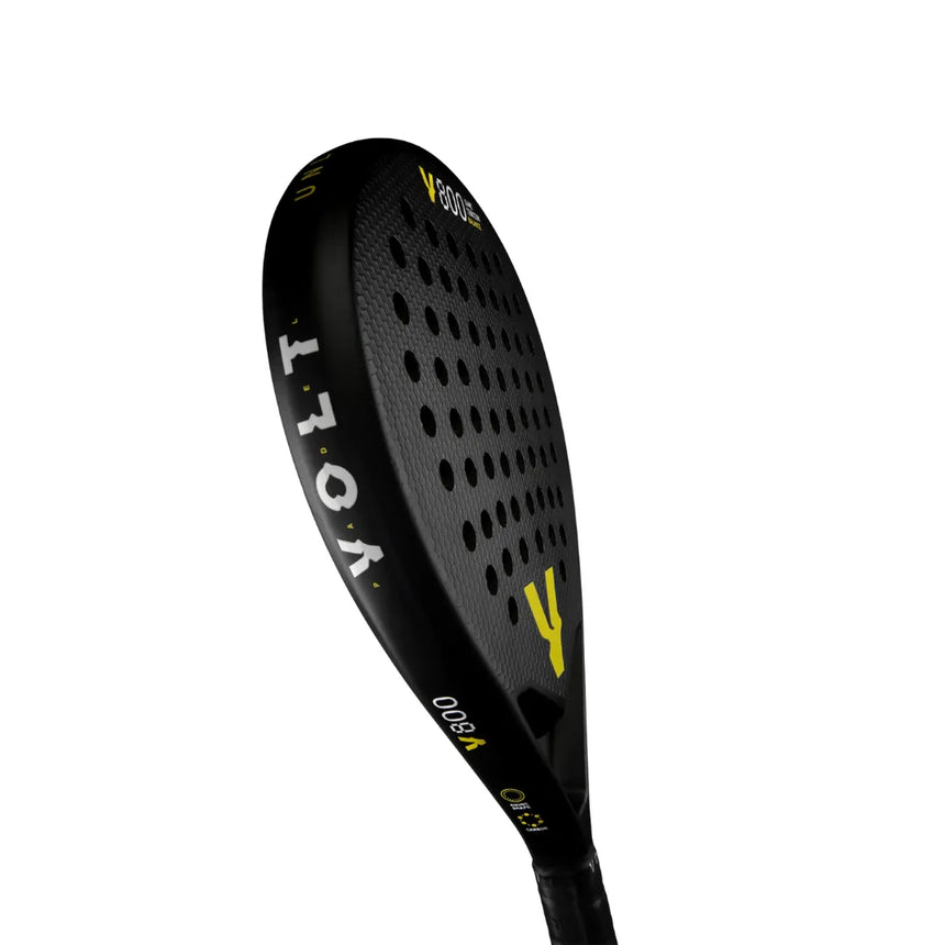 The VOLT 800 V23 padel racket, black and yellow with small perforations, features the brand Volt and is crafted with Fast Recovery Black Eva for high control. The tilted paddle showcases its 3K carbon surface and edge against a white background.