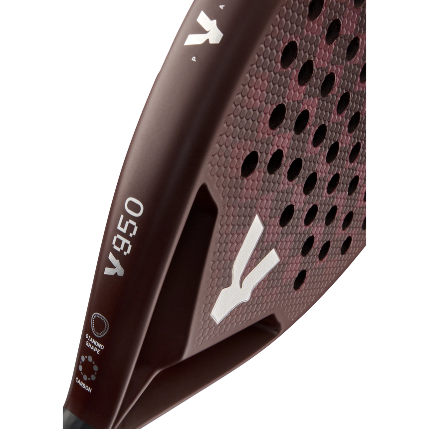 Close-up of the maroon VOLT 950 V23 padel racket by Volt, designed for advanced players. It features a hexagonal grid pattern and a handle with small white logos. Crafted for power and control, its matte surface displays a refined carbon texture.