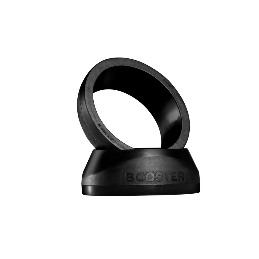 The sleek VOLT BOOSTER by Volt is a black ring with BOOSTER embossed, angled on a matching base against a dark backdrop. This padel racket accessory combines modern aesthetics with a power boost for your game.