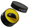 The cylindrical black container labeled BOOSTER and VOLT, with a lightning bolt design on the lid, reveals a circular device inside. Its yellow interior hints at a power boost, making it perfect for padel racket accessory enthusiasts. Product: VOLT BOOSTER by Volt.