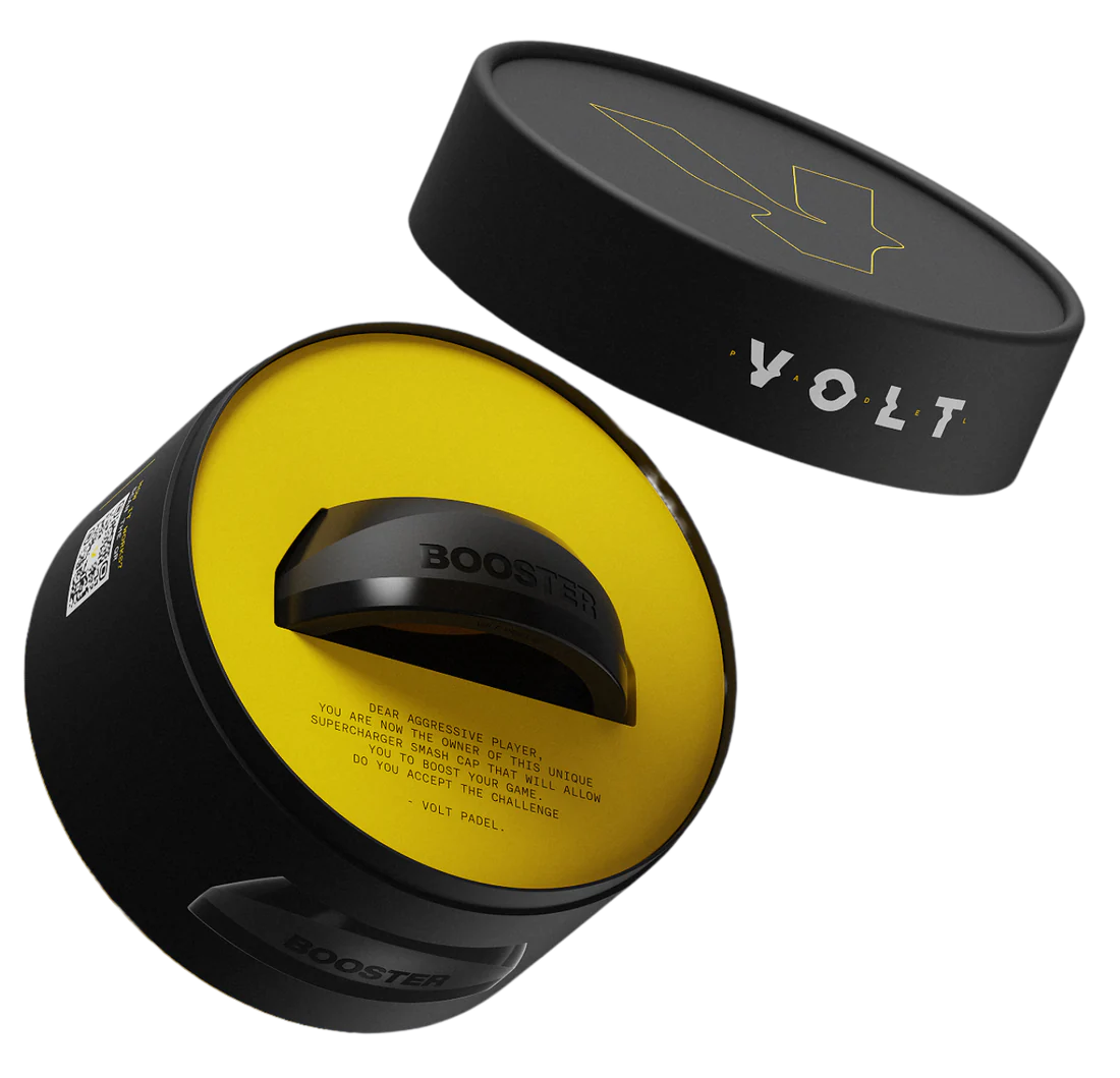 The cylindrical black container labeled BOOSTER and VOLT, with a lightning bolt design on the lid, reveals a circular device inside. Its yellow interior hints at a power boost, making it perfect for padel racket accessory enthusiasts. Product: VOLT BOOSTER by Volt.