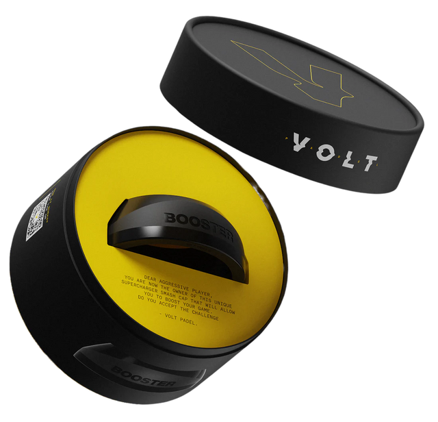 The cylindrical black container labeled BOOSTER and VOLT, with a lightning bolt design on the lid, reveals a circular device inside. Its yellow interior hints at a power boost, making it perfect for padel racket accessory enthusiasts. Product: VOLT BOOSTER by Volt.