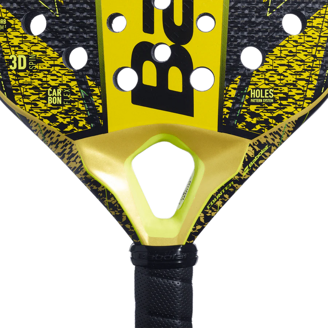 Close-up of the Babolat Counter Veron 2024 padel rackets head in yellow and black, showcasing CARBON FLEX technology. A central hole is near the throat, with a textured carbon surface and the brand name partially visible in bold letters.