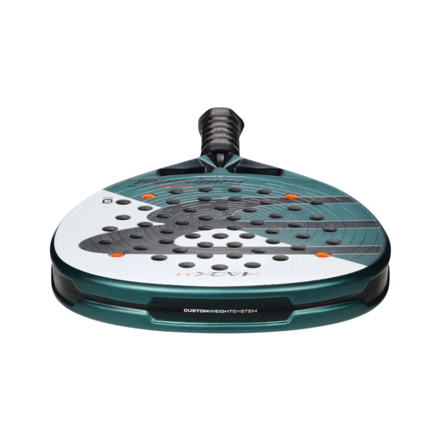 The BULLPADEL RACKET HACK 04 2025 PAQUITO NAVARRO by Padel Smash Academy features a teal and white design with Total Channel technology, multiple perforations, orange accents, a black grip, and custom weight system text. The low-angle shot highlights its dynamic appeal.