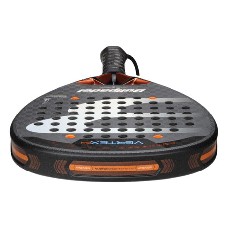 Close-up of the BULLPADEL RACKET VERTEX 04 2025 JUAN TELLO by Padel Smash Academy, like new. It features a black and orange design with a perforated face and wrist strap for total control. Dynamic patterns and branding complete its sleek look.