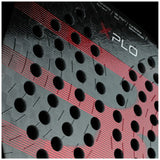 A close-up of the BULLPADEL RACKET XPLO 2025 MARTÍN DI NENNO by Padel Smash Academy highlights black hole patterns with red and black geometric stripes. The word XPLO is partially visible at the top.