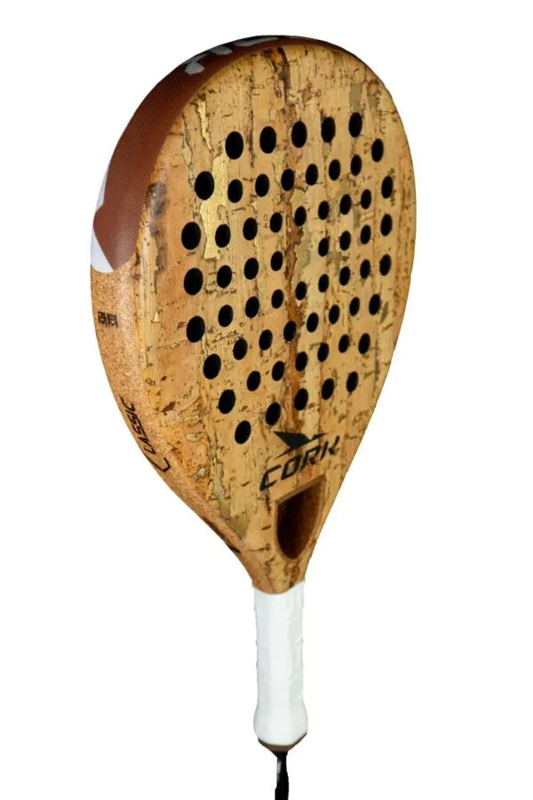 The Cork Padel Classic by Cork Padel boasts a cork-textured surface and an innovative pattern of small holes. Wrapped with white grip tape, its handle provides comfort and control, ideal for players seeking precision in every swing.