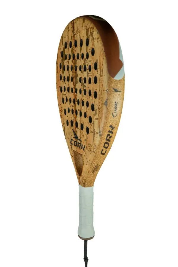 The Cork Padel Classic by Cork Padel features an innovative drilling pattern with circular holes and a cork-like texture for better comfort and control. A white grip tape wraps the handle, displaying CORV and CORK prominently on its surface.