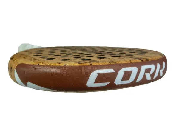The Cork Padel Classic by Cork Padel features a cork surface with black dots, CORK in white on a brown side, and an innovative drilling pattern for enhanced comfort and control. The handles light grip ensures optimal playability.