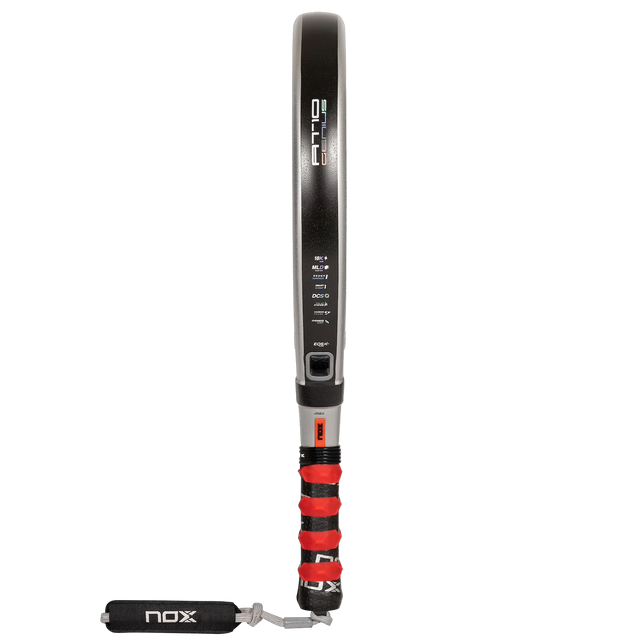 The NOX AT10 Genius 18K padel racket by Agustín Tapia, available at Padel Smash Academy, features EOS Flap technology, a sleek black frame with red grip, side branding and specs, and a wrist strap imprinted with NOX.