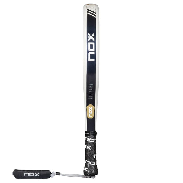 The NOX Padel Racket Equation Advanced Series 2025, known for precision, stands upright with a black and white color scheme with gold accents. It features a textured grip, wrist strap, and prominently displays the logo and EQUATION Advanced branding on the surface.