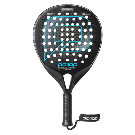 The PALLAP CONTROL VELOCITY PRO 01 racket, ideal for advanced players, features a black design with a large P logo and white polka dots. It showcases ROCKSOLID 12K, HYPERSKIN PBO, and carbon engineering. The handle includes a grip and branded wrist strap for secure play.