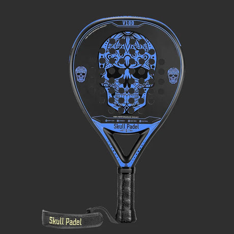 The SKULL PADEL V100 | BLUE EDITION (KIDS) from Skull Padel features a striking blue and black design with an ornate skull on the face. It includes a wrapped grip and a Skull Padel wrist strap against a dark background.