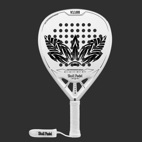 The SKULL PADEL V1100 - WHITE LEAF 24K (LIKE NEW) by Skull Padel is a white racket with a black feather design, crafted from carbon fiber. It features a perforated pattern on a dark background, and the handle has white tape labeled Skull Padel, offering a secure grip and an attached wrist strap.