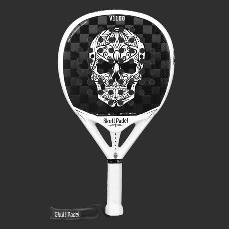 The SKULL PADEL V1150 - WHITE SKULL 24K, from Skull Padel, is a black and white padel racket with a carbon fiber frame. It features a skull graphic with floral and geometric designs. The white handle includes Skull Padel branding and has a detachable strap for extra style.