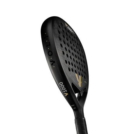 The black VOLT 1000 V23 padel racket from Volt features a perforated surface and diamond-shaped blade for aggressive play. Its sleek, modern design is enhanced with gold and white lettering for top court performance.