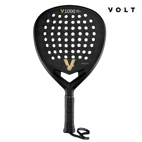 The VOLT 1000 V23 padel racket by Volt is tailored for aggressive players, featuring a diamond-shaped blade with a perforated surface, VOLT branding, and a bold V design at the center. It has a black handle with a wrist strap and displays Volt 1000 V23 at the top.