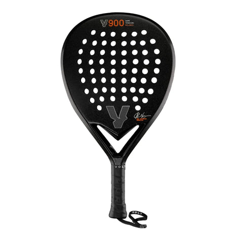 The VOLT 900 V23 by Padel Smash Academy features a robust black 3K carbon round paddle with circular holes. An orange V900 adorns it next to a gray V logo. The handle, wrapped in black with a wrist strap, echoes those used by Ana Catarina Nogueira.